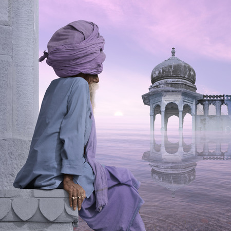 Indian old man meditating on the Ganges in the sunrise.の写真素材