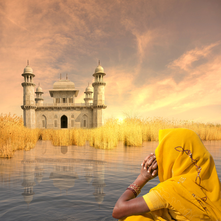 Indian woman with yellow saree on the Ganges.の写真素材