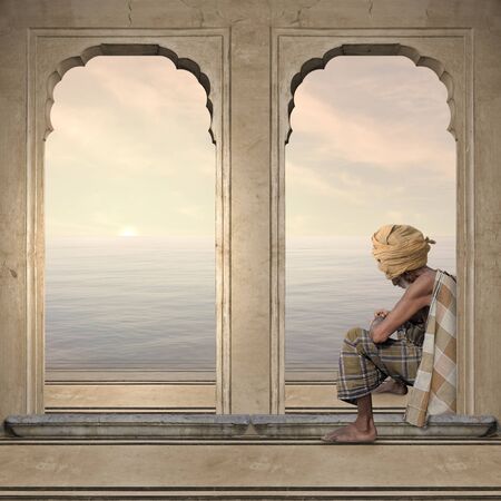 Old man on a indian arch during the sunset.の写真素材