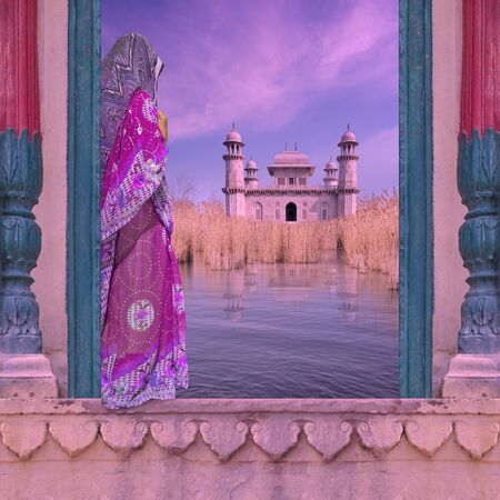 Indian woman with saree on a window near Ganges river.の写真素材