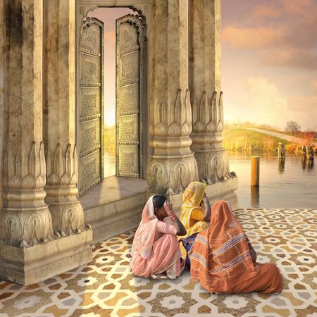 Women near a traditional indian door in the sunrise.の写真素材