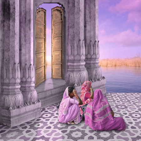 Women near a traditional indian door in the sunrise.の写真素材