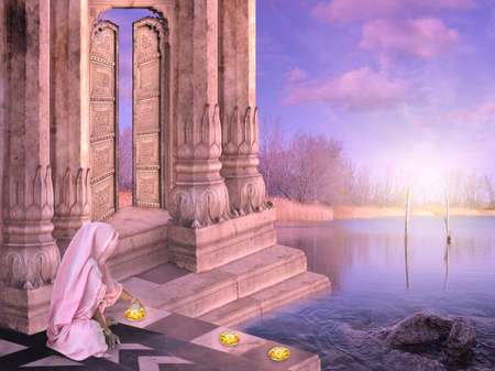 Indian woman celebrating diwali with candles during the sunset.の写真素材