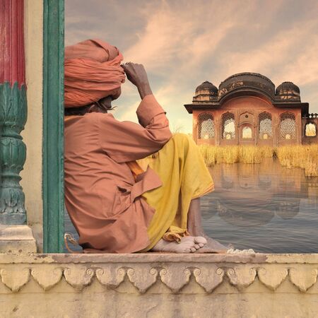 Holy man on a old wall near Ganges river.の写真素材
