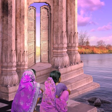 Women near a traditional indian door in the sunrise.の写真素材