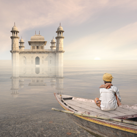 Indian fisherman sailing to a palace in the mist.の写真素材