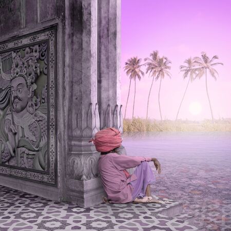 Sadhu meditating in a temple during the sunrise.の写真素材
