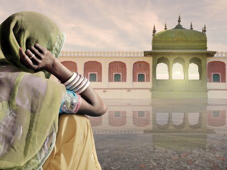 Woman with saree near typical indian monument.の写真素材