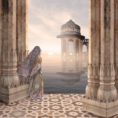 Indian woman in a hindu temple during the sunrise.の写真素材