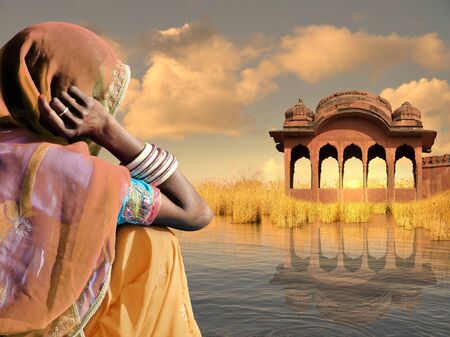 Indian woman with saree near Ganges river.の写真素材