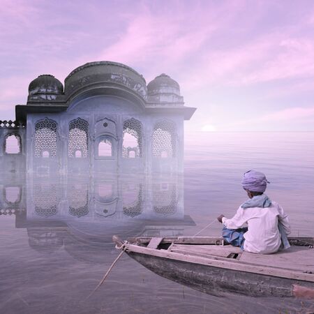 Indian fisherman working on his boat in the mist.の写真素材