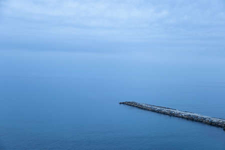 In the town of BenalmÃ¡dena, summer days are usually clear but in the early morning there are clouds and hazeの写真素材