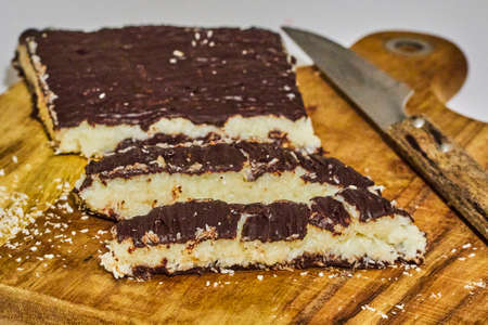 Slides and turron block with chocolate and coconut on chopping board
