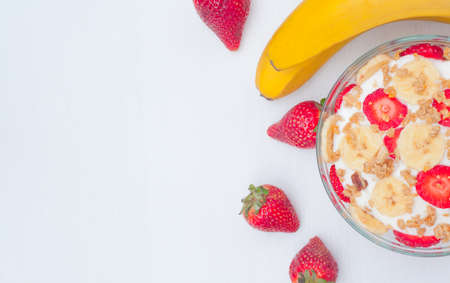 Greek yogurt with muesli, strawberries and bananasの写真素材