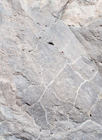 Abstract grey stone background with cracks. Macro