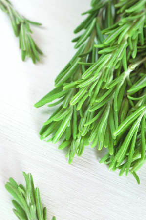 Fresh rosemary twigs on white wooden backgroundの写真素材