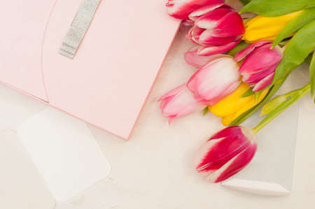 Bouquet of tulips,  gift box and blank greeting card on the wooden backgroundの写真素材