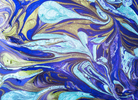 Abstract blue and golden nail polish background. Close-up image