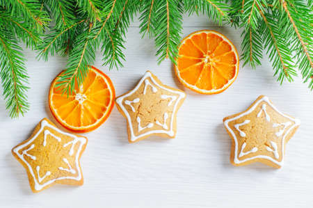 Gingerbreads and Christmas tree branches on the wooden backgroundの写真素材