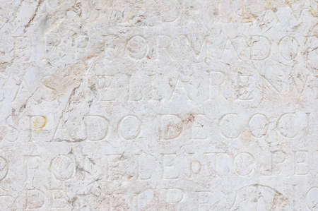 Background with old latin inscription on the stoneの写真素材
