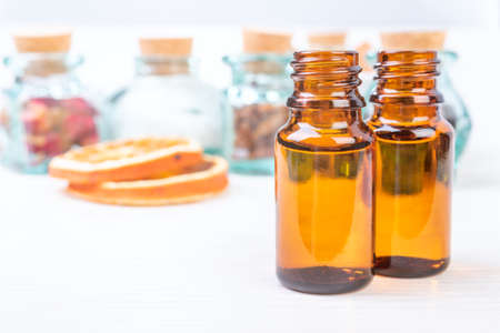 Essential oils in glass bottles on wooden backgroundの写真素材