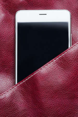 Smartphone in the leather bag pocket. Close-upの写真素材