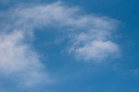 Abstract background with white clouds on the blue skyの写真素材