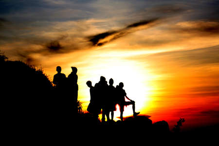 silhouette of people in front of a beautiful sunriseの写真素材