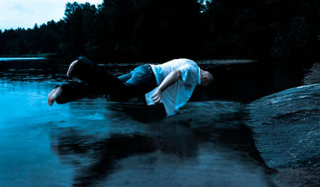 Levitating Sleepwalker over waterの写真素材