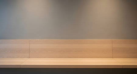 Grey showing minimalist light wood bench against a neutral grey wall with soft overhead...の写真素材