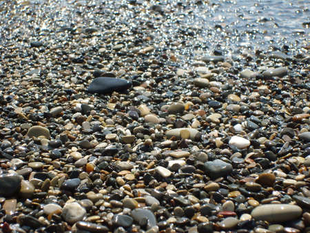 Pebbles on the beach with sea wave