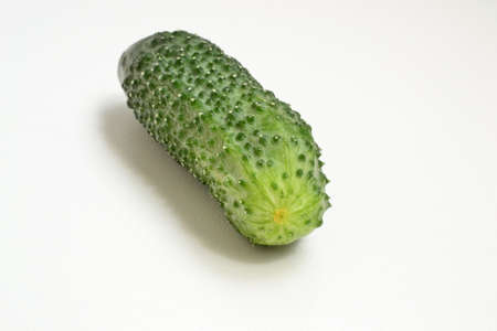 Green cucumber on a white background on the tableの写真素材