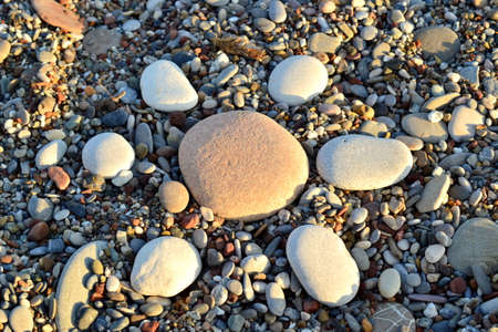 Stone sun on the beach sea
