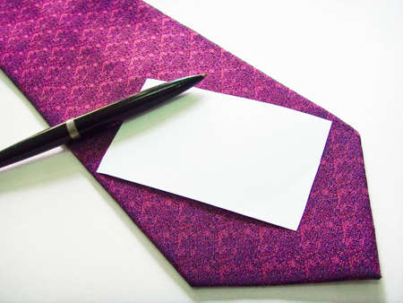 A name card on a purple business tie with a penの写真素材