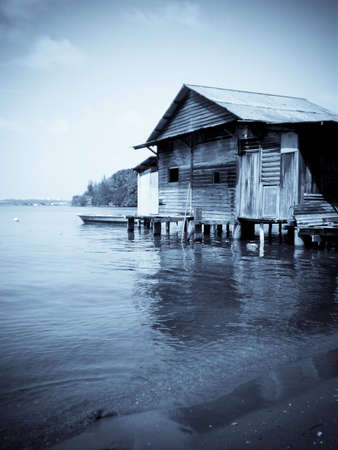 A old wooden house on the water in selenium toneの写真素材