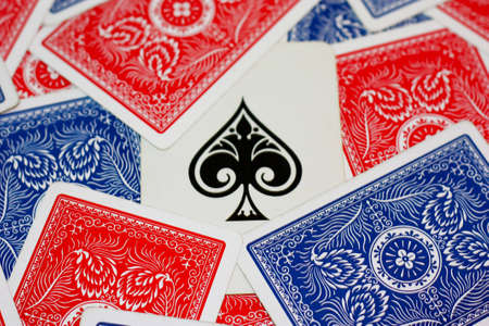 Red and blue [playing card scattered around the ace of spades