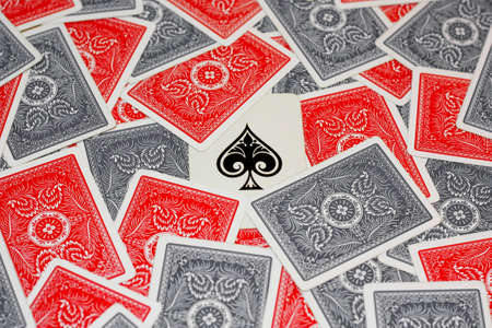 Ace of spade in the centre surrounded by red and grey playing cardsのeditorial素材