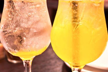 Cold glasses with black straws filled with lime drinkの写真素材