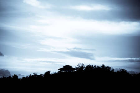 A hut isolated on a hill at a distanceの写真素材