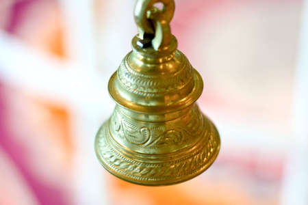 A golden bell with beautiful carvings. This bell is used for decoration and prayers by hindus. 