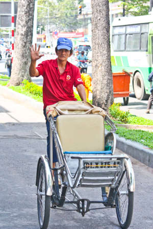 Ho Chi Minh City, Vietnam - June 10, 2010 - A friendly cyclo driver along the roads of Ho Chi Minh City in Vietnam. のeditorial素材