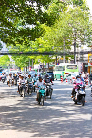 Ho Chi Minh City, Vietnam - June 10, 2010 - A congested road with motorist riding on a road with eletrical wires dangling dangerously below their heads on Ho Chi Minh street in Vietnam. のeditorial素材