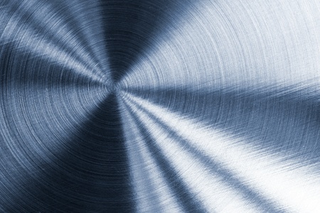 Cold blue metallic texture with circular reflections and surface patterns.の写真素材