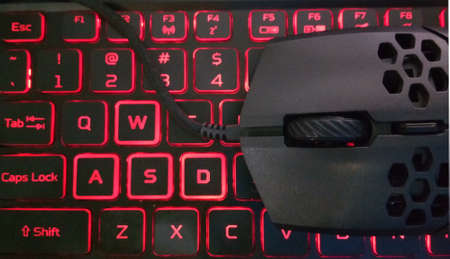 Perforated gaming mouse on the LED red Keyboard. This picture was taken from the above gaming laptopの写真素材