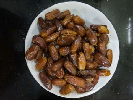 Dates on a plate. Kind of this dates is deglet dates. Dates origin comes from middle eastの写真素材