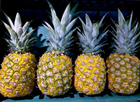 Close up photo of pineapples on the fresh fruit marketの写真素材