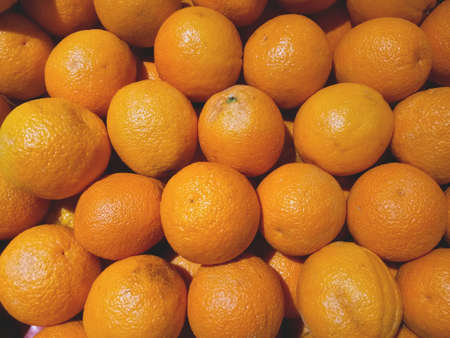Close up photo of stack of oranges on the fresh fruit marketの写真素材