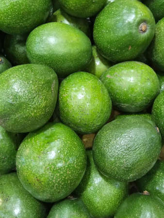 Close up photo of Stack of avocado on the fresh fruit marketの写真素材