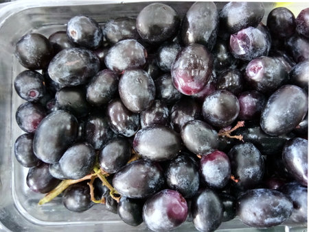 A stack of red grape on the fresh fruit marketの写真素材
