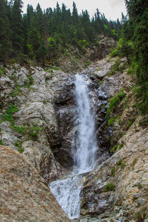 Waterfall in the mountains. Rest is not nature, summer travel, tourism.の写真素材